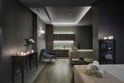 a room with a bed and a bathroom with a sink at Comfy 1bd apartment in 4star SPA resort Bansko in Bansko