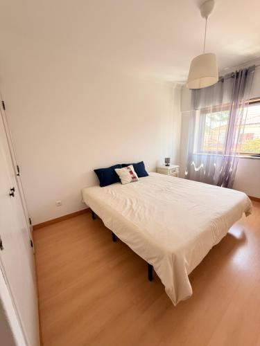 a bedroom with a large white bed in a room at Sunny Marisol T2 in Aroeira