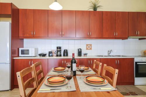 a kitchen with a table with a bottle of wine at Kiveri Gems Houses in Kivérion