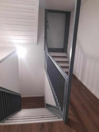 a staircase in a room with white walls and wooden floors at BnB 2 Room sleep 3 - 1x Queensize-Double Bed 1x Single Bed in Wohlen