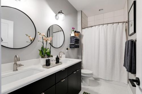 a bathroom with a sink and a toilet and a mirror at Bright and Modern 3BR - Walk to Dining and Park in Richmond