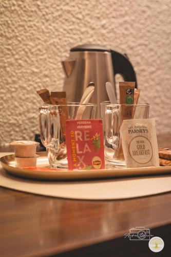 a tray with glasses and a coffee maker on a table at Hotel Chantereyne in Cherbourg en Cotentin
