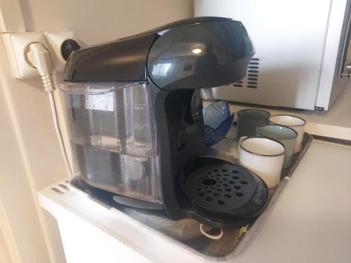 a black coffee maker sitting on top of a counter at 2 Bed House with Mountain View Garden and Bbq in Confolens