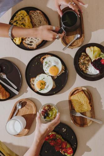 a table full of plates of breakfast foods at Village Aparthotel By BOA in Porto
