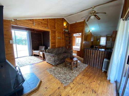 a living room with a couch and a table at Nullarbor Cottages in Magaliesburg
