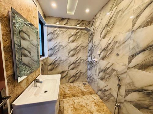 a bathroom with a sink and a shower at Modern Villa DHA in Lahore