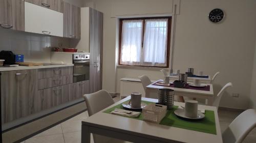 a kitchen with a table and chairs in a room at Bed and Breakfast Arcobaleno - Rieti in Rieti