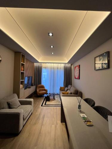 a living room with a couch and a table at The Diamond In City Luxury Suites By ZENORA Living in Accra