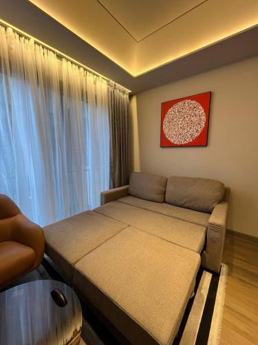 a small bedroom with a bed and a window at The Diamond In City Luxury Suites By ZENORA Living in Accra