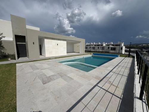 a swimming pool on the side of a house at Riscos Suite Loft in Hércules