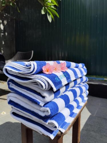 a pile of towels sitting on top of a table at 3R Resort by Blue Bird in Negombo