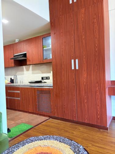 a kitchen with wooden cabinets and a table at Skydeck by 2nd Homes in Dehradun