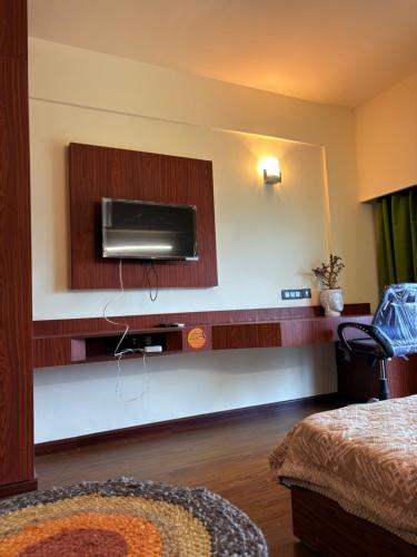 a room with a tv on the wall at Skydeck by 2nd Homes in Dehradun