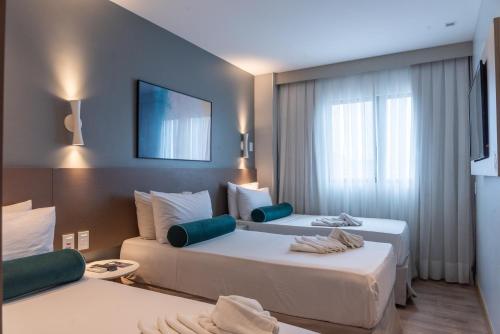Ένα ή περισσότερα κρεβάτια σε δωμάτιο στο Hotel Água de Coco
