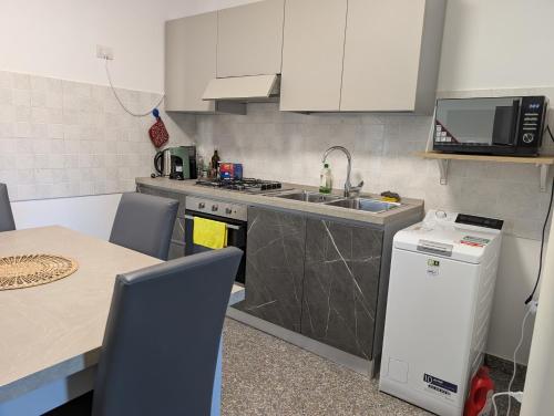 a kitchen with a sink and a stove and a table at Venice Luxury Apartment in Venice