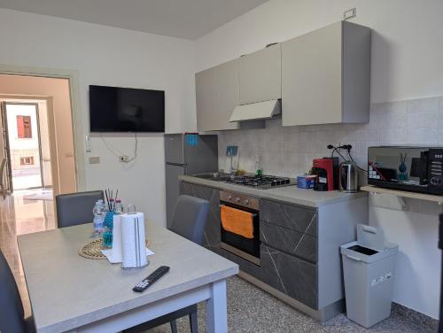 a kitchen with a table and a stove top oven at Venice Luxury Apartment in Venice