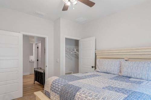 a bedroom with a bed and a ceiling fan at Spacious 4BR Home Near Midtown & FSU in Saint Peter