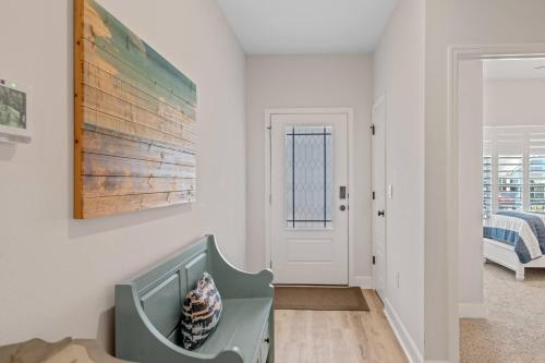 a white room with a baby crib in front of a door at Spacious 4BR Home Near Midtown & FSU in Saint Peter