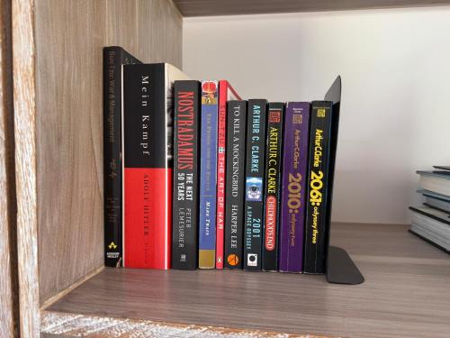 a row of books sitting on a book shelf at The Mountain Links, Upcot, Nuwara Eliya in Maskeliya