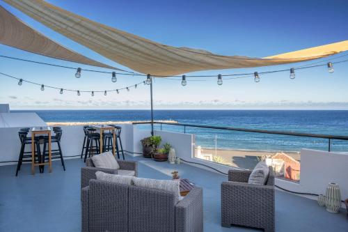 a patio with chairs and a view of the ocean at Banana Garden La Palma in Santa Cruz de la Palma