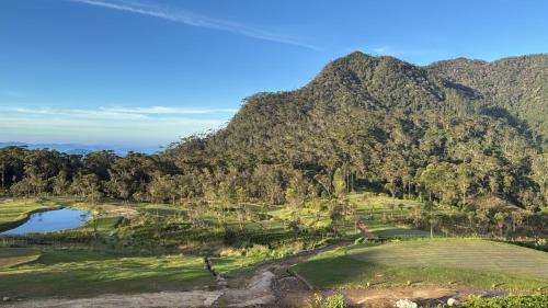 an aerial view of a golf course with mountains at The Mountain Links, Upcot, Nuwara Eliya in Maskeliya