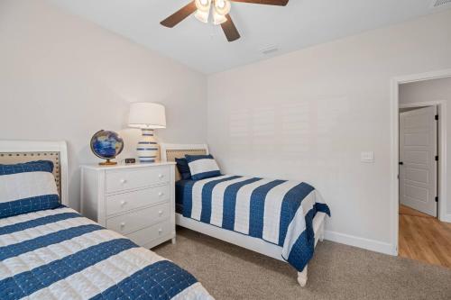 a bedroom with two beds and a ceiling fan at Spacious 4BR Home Near Midtown & FSU in Saint Peter