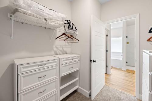 a bedroom with white cabinets and a closet at Spacious 4BR Home Near Midtown & FSU in Saint Peter