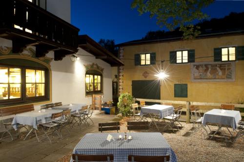 a patio with tables and chairs in front of a building at Hotel Hörterer Der Hammerwirt in Siegsdorf