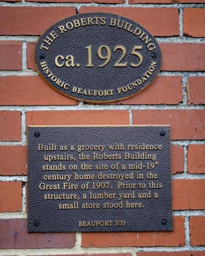 a plaque on the side of a brick building at City Loft Hotel in Beaufort