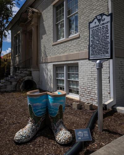 a pair of rain boots in front of a building at City Loft Hotel in Beaufort