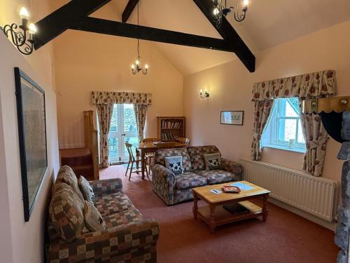 a living room with a couch and a table at The Dairy, Magheramore Courtyard in Dungiven