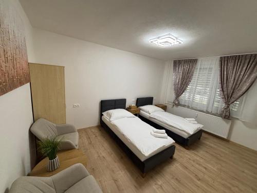a room with two beds and a couch in it at ARD Apartment Nitra Centrum in Nitra