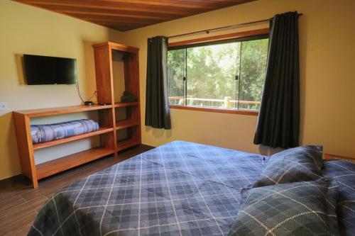 En eller flere senge i et værelse på Casa Raizes da Natureza