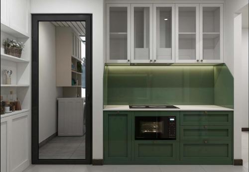 a kitchen with green cabinets and a mirror at Rio House district 10 Saigon Centrosa in Ho Chi Minh City