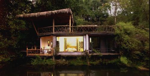 a house in the middle of the water at Subtropica Forest Suites in Mindo