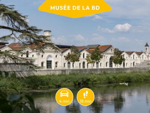 a large white building next to a body of water at Besson Bey I - Idéal couple & pros - 8min en voiture du Festival de la BD - 14min à pied de la gare - 5min à pied du parc de Bourgines - Wifi THD - Netflix in Angoulême