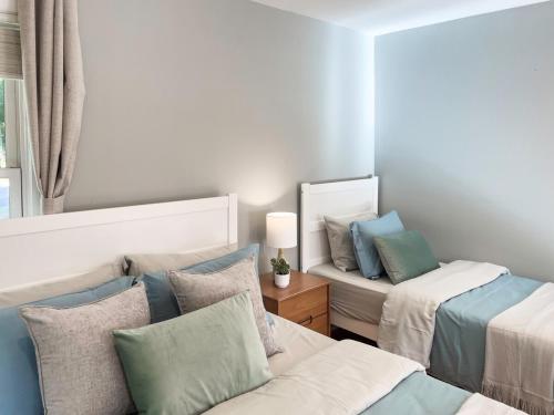 a living room with two beds and a mirror at Serenity Haven - A Modern Retreat in Monroe