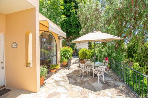 a patio with a table and an umbrella at Casa Estrella de la Valenciana Hotel Boutique in Guanajuato