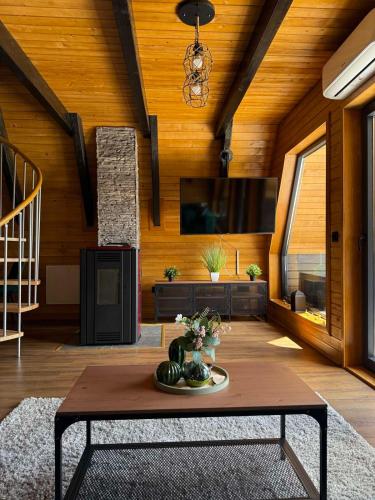 a living room with a table and a tv at Villa Merima Vlasic in Vlasic