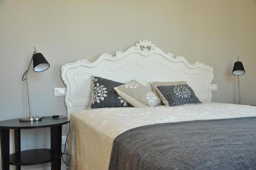 a bedroom with a white bed with pillows on it at AL 32 B&B in Massa Marittima