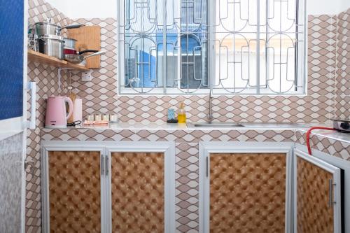 a kitchen with a sink and a window at Tulizo Villas Paje in Paje