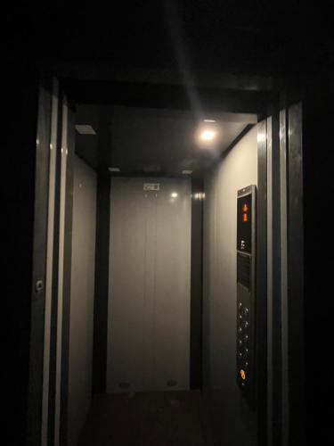 a dark room with a hallway with a elevator at The Aura premium Homestay near Paltan bazar Gs road in Guwahati