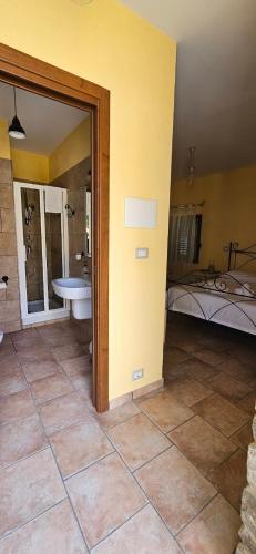 a room with a bathroom with a tub and a bed at DE LERMA by Keyhole Selection in Castelmezzano
