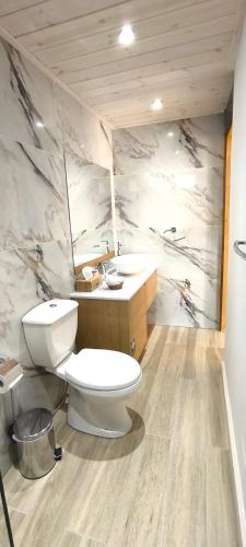 a bathroom with a toilet and a sink at The Zephyr House in Pyrgos