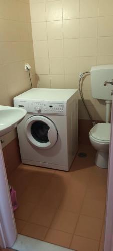 a washing machine in a bathroom with a toilet at Lefkes Horizon in Lefkes