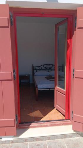 an open door to a bedroom with a bed at Lefkes Horizon in Lefkes