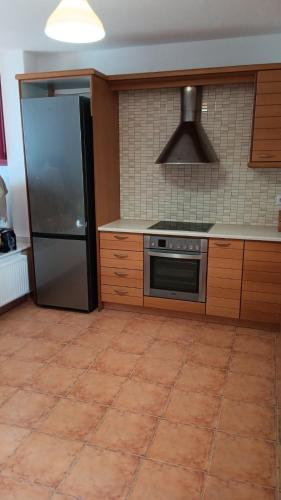 a kitchen with a stove and a refrigerator at Lefkes Horizon in Lefkes