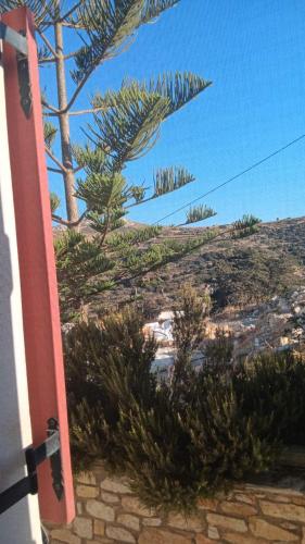 a door to a house with trees on a hill at Lefkes Horizon in Lefkes