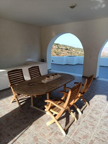 a table and chairs in a room with a bed at Lefkes Horizon in Lefkes