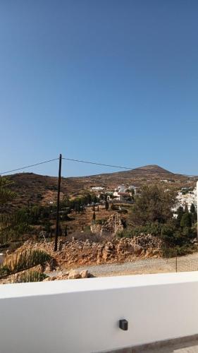 a view of a hill with a town in the distance at Lefkes Horizon in Lefkes